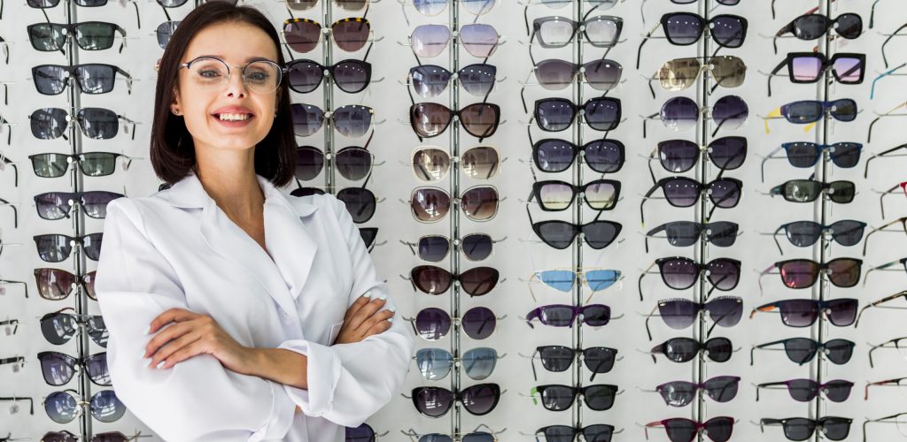 medium-shot-optician-with-sunglasses-display